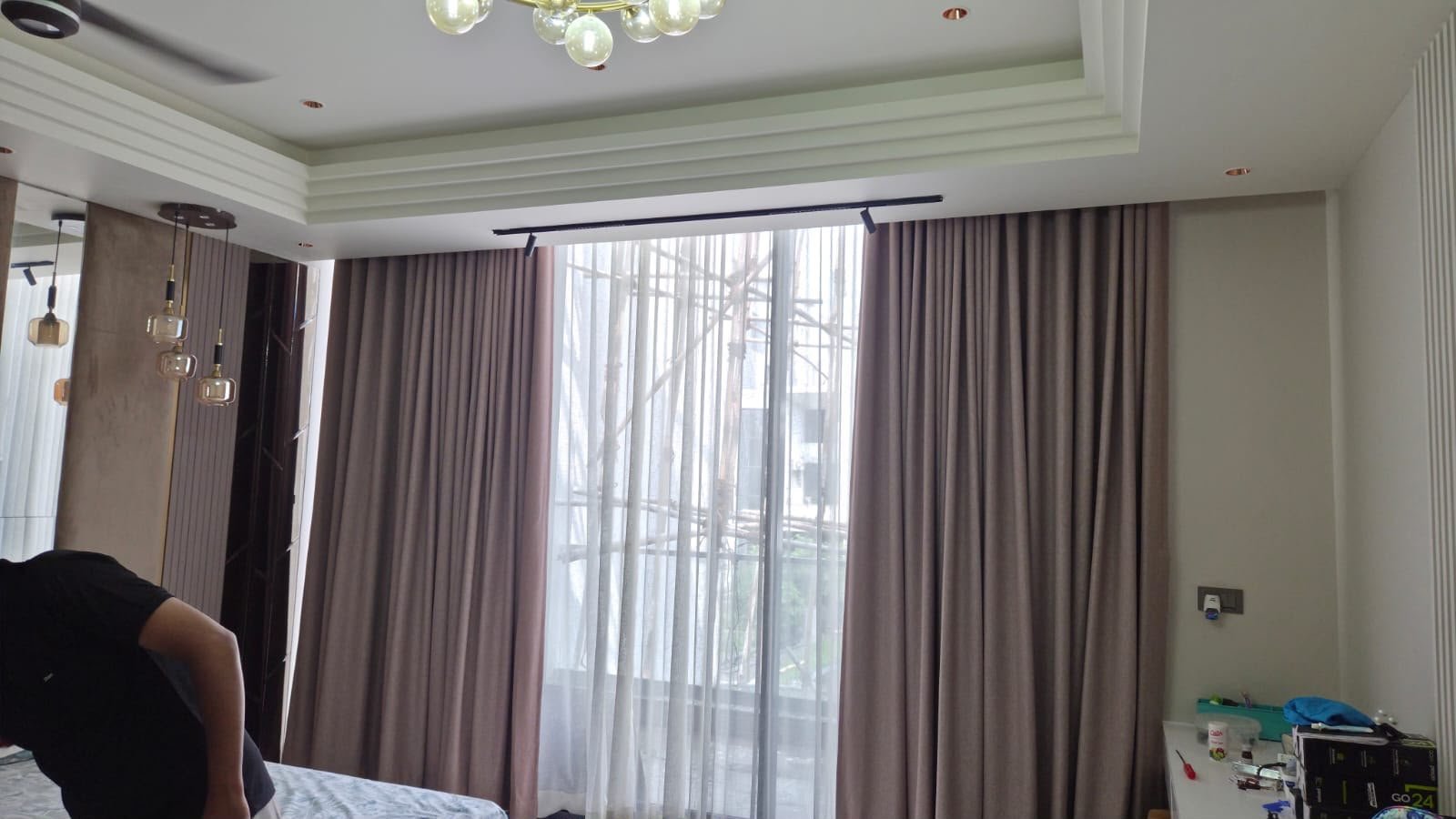 Black ceiling curtain track with blackout curtains